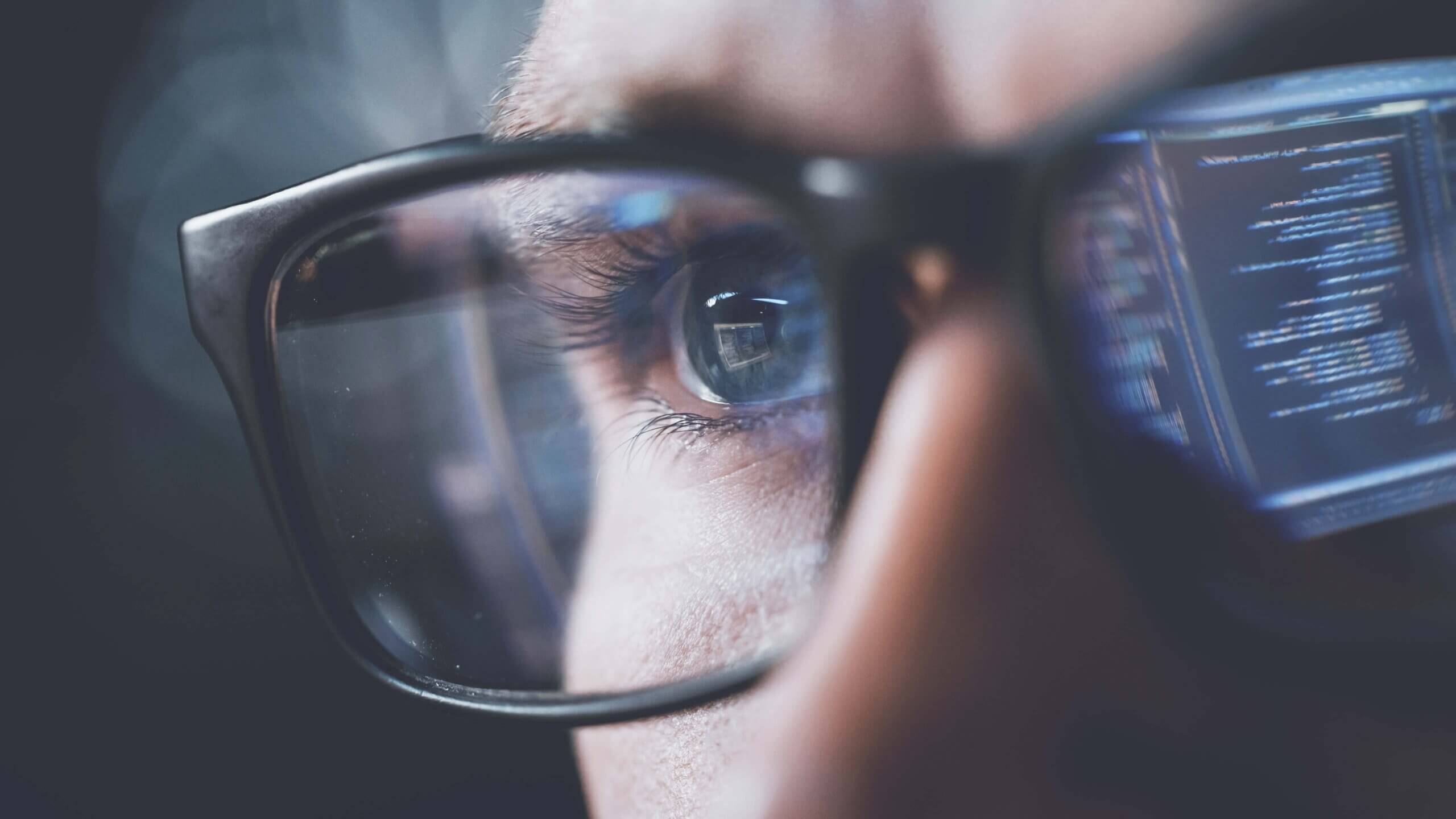 Data reflected in eyeglasses, symbolizing analysis and expertise in fund administration services.